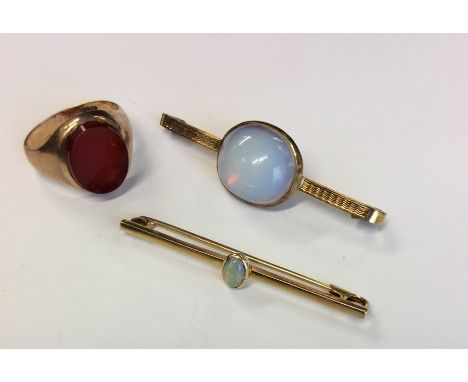 A small gold opal brooch together with a gent's gold signet ring and a gilt brooch. Approx. 15 grams. Est. £40 - £60.