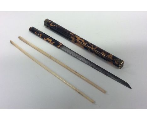 An unusual Asian chopstick and knife set in tortoiseshell sleeve. Est. £80 - £120.
