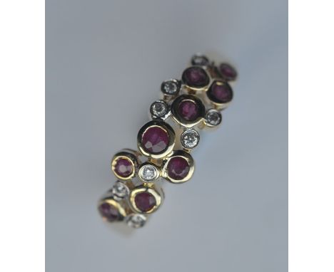 An unusual ruby and diamond cocktail ring in 9 carat mount. Approx. 4 grams. Est. £80 - £120.