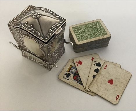 A novelty silver playing card holder in the form of a Sudan chair decorated with scrolls to hinged top. Birmingham. By SJ. Ap