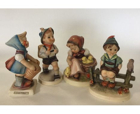 A group of four Hummel figures of children. Est. £20 - £30.
