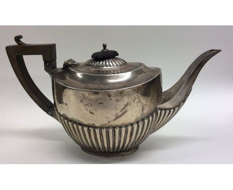 A bachelor's half fluted silver teapot with hinged top. Birmingham. Approx. 188 grams. Est. £60 - £80.