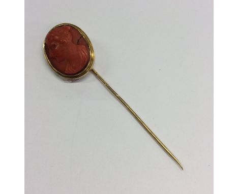 An Antique gold coral stick pin with twisted pin. Approx. 6 grams. Est. £50 - £80.