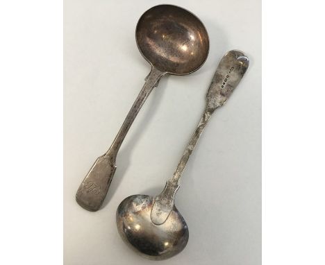 A silver fiddle pattern sauce ladle. London. By GA. Together with one other. Approx. 142 grams. Est. £30 - £40.