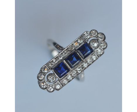 A good sapphire and diamond cocktail ring with rounded ends in platinum mount. Approx. 7 grams. Est. £2500 - £3500.