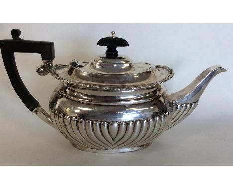 A small silver half fluted bachelor's teapot of typical design. London. By JJ. Approx. 430 grams. Est. £150 - £200.