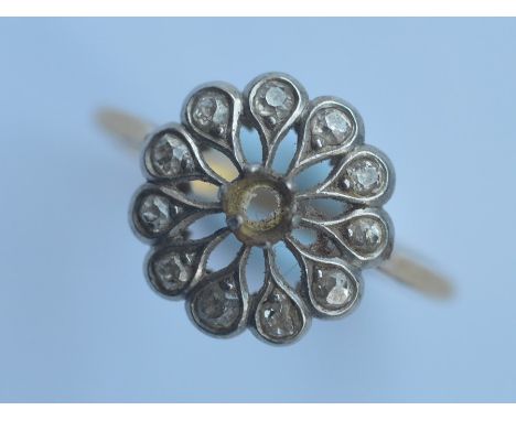 An 18 carat and platinum mounted cluster ring. Approx. 3 grams. Est. £40 - £60.