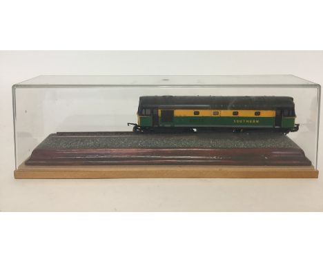 LIMA: An 00 gauge green and yellow Southern locomotive numbered 33259 resting upon a line of trackupon a wooden plinth, conta