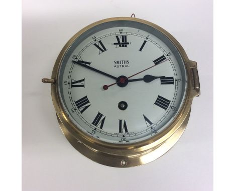 A brass timepiece with roman numerals and red sweep seconds' hand to white enamelled dial. Approx. 18 cms across. Est. £60 - 