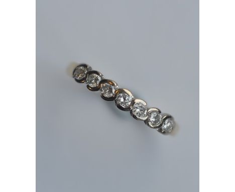 A good seven stone diamond half hoop ring in 18 carat two colour gold mount. Est. £80 - £120.