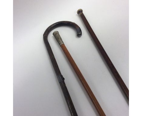 A silver mounted walking cane together with a swagger stick. Est. £20 - £30.