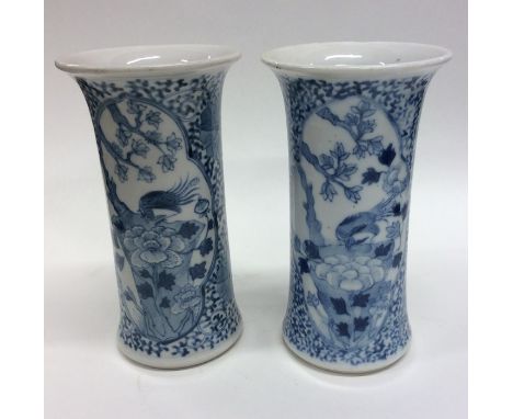 A pair of Chinese blue and white vases decorated with birds and flowers. Seal mark to base. Approx. 15 cms high. Est. £50 - £