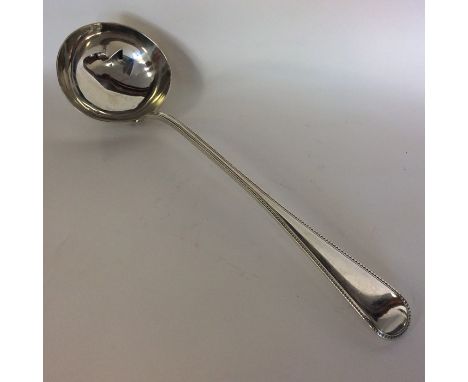 A heavy silver bead edge soup ladle. London. By GA. Approx. 272 grams. Est. £150 - £200.