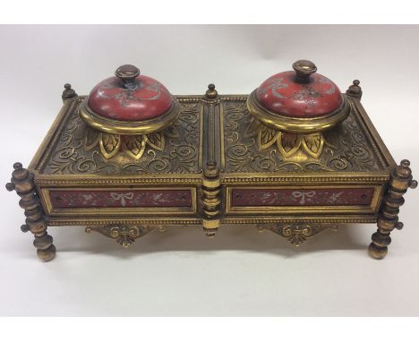 A good Continental brass inkwell decorated with scrolls and flowers. Est. £80 - £120.
