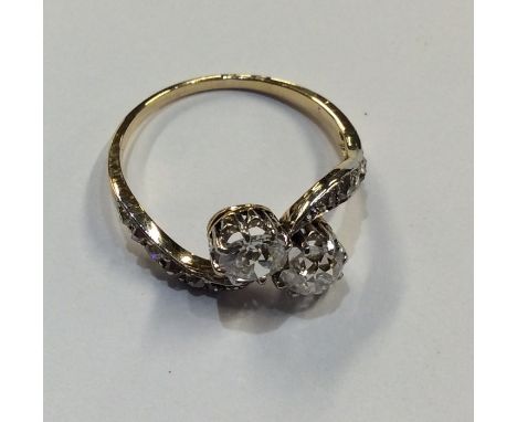 A good diamond two stone crossover ring in scroll claw mount, each stone approx. 0.5 carats. Approx. 3 grams. Est. £800 - £12