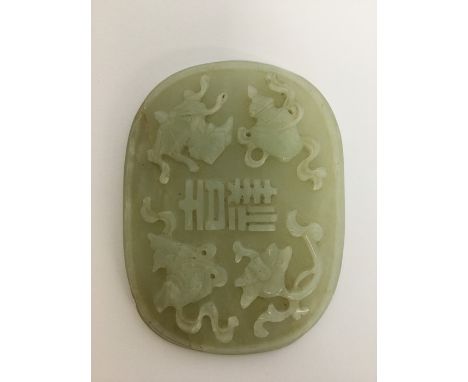 A large Chinese oval carved jade panel. Approx. 85 grams. Est. £40 - £60.