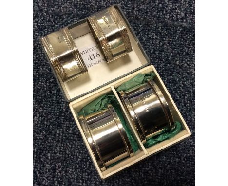 A good pair of engine turned napkin rings together with a similar pair. Approx. 84 grams. Est. £25 - £35.