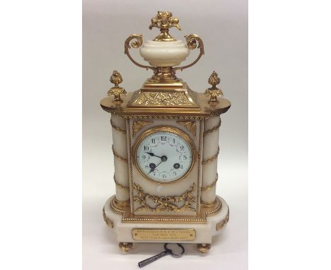 An attractive French marble and brass mantle clock, the white enamelled dial decorated with flowers and swags to striking mov