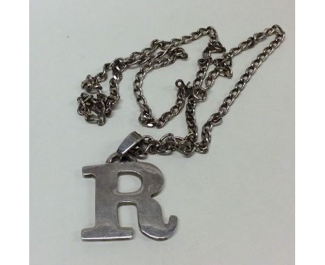 A silver medallion in the form of the letter "R". London. By A&amp;S. Approx. 32 grams. Est. £25 - £35.