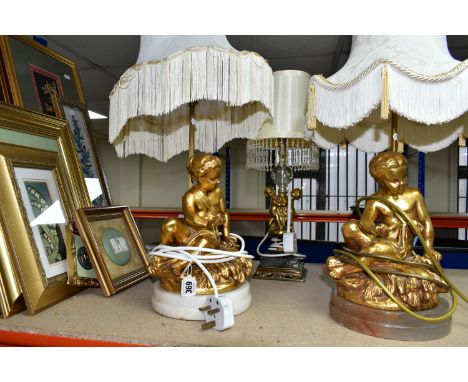 A GROUP OF LAMPS AND GILT FRAMED PRINTS, comprising a small figural standard lamp with cherubs around the base, with a fringe