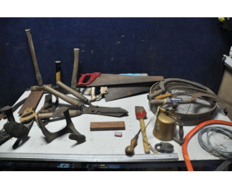 A SELECTION OF VINTAGE TOOLS to include four vintage scythes, vintage saws, two pairs of loppers, saws, hammers, two cobblers