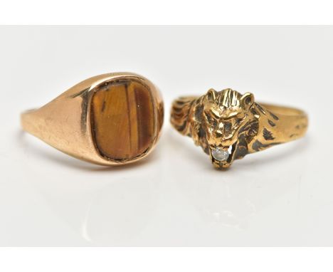 TWO 9CT YELLOW GOLD GEM SET RINGS, to include a ring designed as a lion's head, with a colourless paste set within the lions 