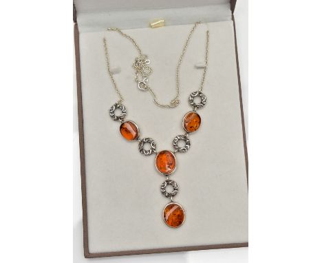 A COPAL AMBER NECKLACE, four oval copal amber stones collet set in a white metal necklet, interspaced between open work desig