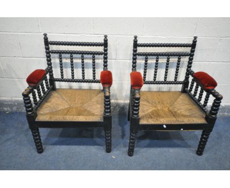 A PAIR OF 20TH CENTURY EBONISED BOBBIN TURNED ARMCHAIRS, with red velvet armrests, and rush seats, width 64cm x depth 49cm x 
