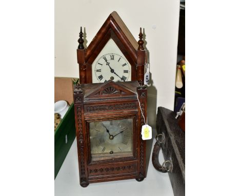 A WINTERHALDER AND HOFMEIER OAK CARVED OAK MANTLE CLOCK, the silvered dial having roman numeral hour markers, the case front 