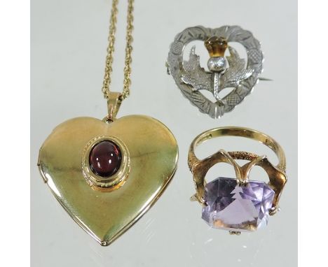 A 9 carat gold and amethyst single stone ring, together with an unmarked locket on a chain and a Scottish silver brooch 