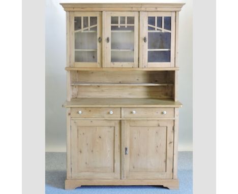 A Victorian pine dresser, with a glazed upper section and cupboards below, on bracket feet, 125cm