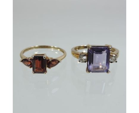 A 9 carat gold amethyst and diamond ring, together with a 9 carat gold garnet three stone ring, each boxed