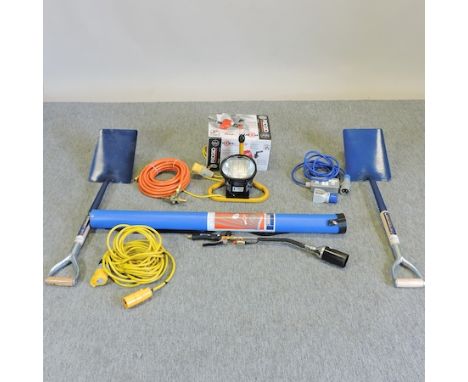 A collection of tools, to include two shovels and a blow lamp