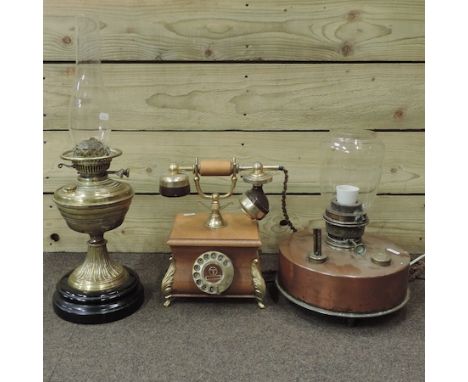 A brass oil lamp, together with a copper lamp and a telephone