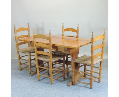 A modern pine kitchen table, 130 x 70cm, together with four rush seated ladder back chairs