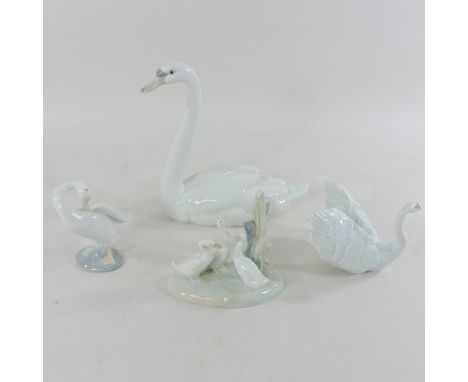 A Lladro porcelain model of a swan, 22cm tall, together with two others and a Nao model