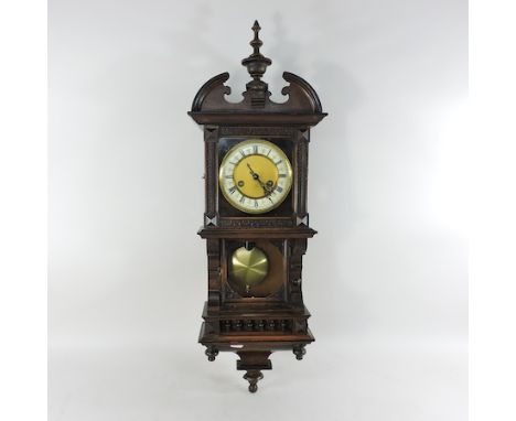 An early 20th century carved walnut drop dial wall clock, 76cm tall