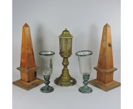 A pair of wooden obelisks, 49cm tall, together with a pair of hurricane lamps and a pierced brass lamp