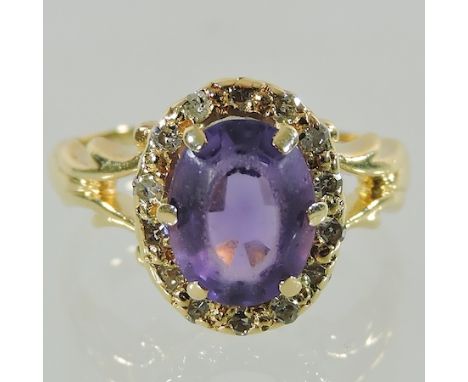 An 18 carat gold amethyst and diamond ring, boxed 