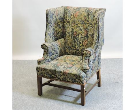A 19th century style tapestry upholstered wingback armchair