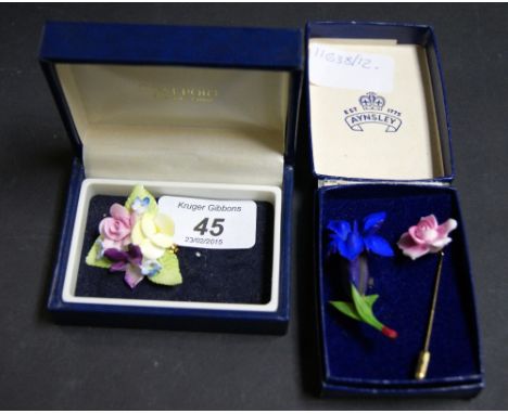 Three ceramic brooches (two of which are cased)