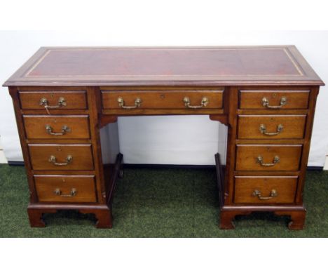 19th century oak and mahogany kneehole desk with tooled leather top, original handles and raised on bracket feet