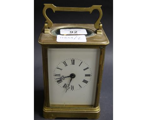 A vintage brass and glass-panelled carriage clock