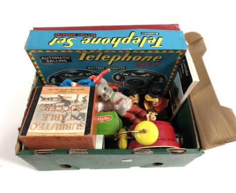 A box of assorted toys and games including Subbuteo, Canasta card game, Arrow toys telephone set, Mickey Mouse alarm clock, D