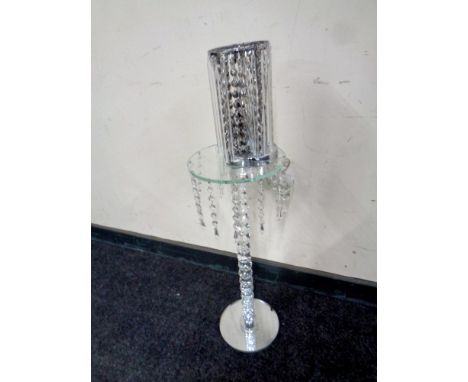 A contemporary glass and crystal wine table with drops together with a contemporary table lamp  