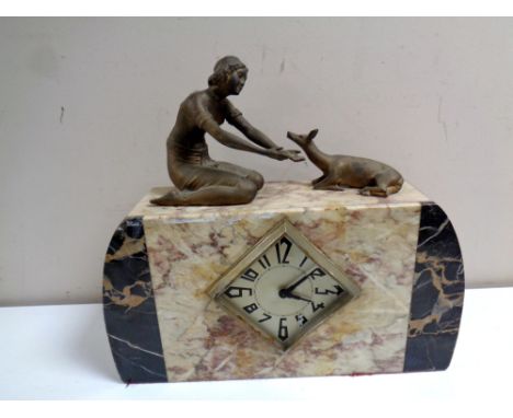 A marble Art Deco mantel clock surmounted by female figure with deer 