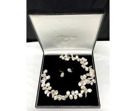 A silver mounted pearl necklace and matching earring set  