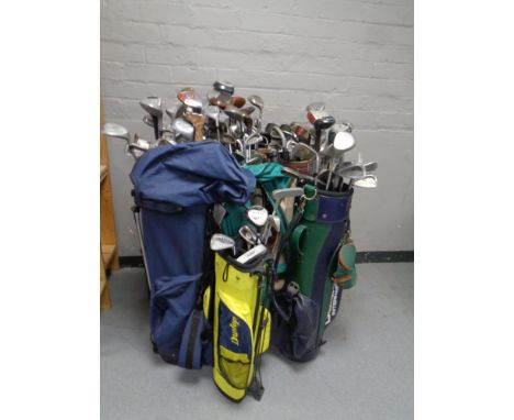 Ten golf bags containing a large quantity of assorted adult's and children's drivers, irons and putters by Spalding, Ping, Ho