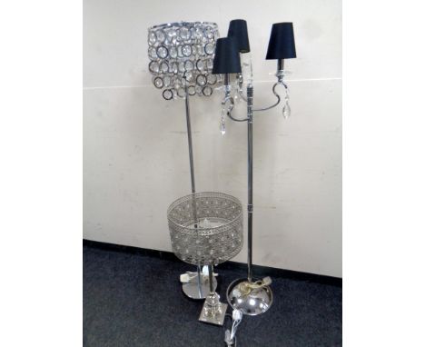 A contemporary table lamp together with two further contemporary floor lamps with glass drops  