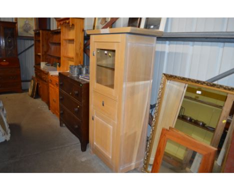 A light oak and glazed cabinet 